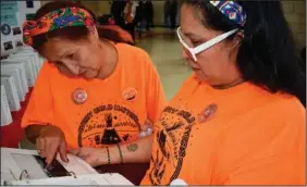  ?? ?? Sanchez (left) points to a photo of the Native American boarding school she was forced to attend as her daughter Candice Left Hand Bull Vigil looks on.