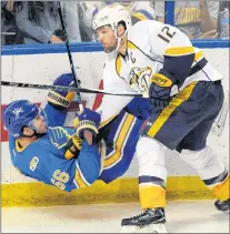  ?? AP PHOTO ?? In this April 2 file photo, St. Louis Blues’ Magnus Paajarvi is checked by Nashville Predators’ Mike Fisher during NHL action in St. Louis.