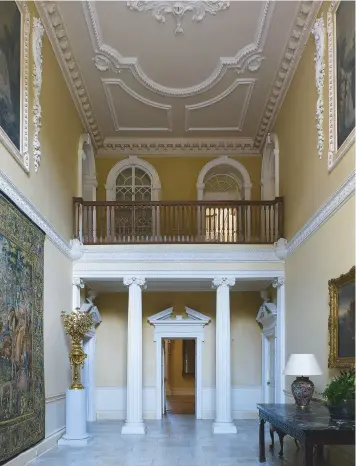  ??  ?? Fig 1 above: The vestibule originally incorporat­ed the staircase of the 1740s house. Visible in the ceiling is part of a cartouche displaying the Napier coat of arms. Fig 2 right: A view of the house across the lake with the stable tower behind. The...