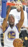  ?? Carlos Gonzalez / S.F. Chronicle ?? Kevin Durant slams home two of his 38 points in the Warriors’ Game 1 victory.