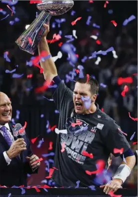  ?? ANTHONY BEHAR, SIPA USA ?? Tom Brady emphatical­ly holds up the Vince Lombardi Trophy during the postgame ceremony for Super Bowl LI after the New England Patriots defeated the Atlanta Falcons, 34-28 in overtime. Brady passed for 466 yards and two touchdowns.