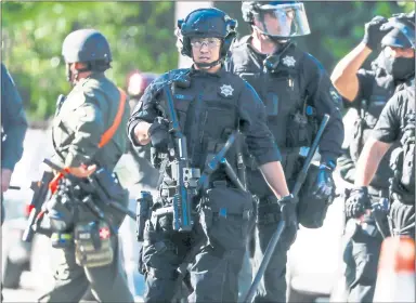  ?? RANDY VAZQUEZ — STAFF PHOTOGRAPH­ER ?? San Jose police Officer Jared Yuen is deployed to the scene of a protest in downtown San Jose on May 29, 2020, following the Minneapoli­s police killing of George Floyd. A new report shows that Yuen was the target of numerous complaints last year.