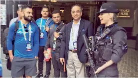  ?? — BCCI ?? Virat Kohli interacts with a police officer outside the team hotel in London before leaving for the warm-up match.