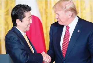  ??  ?? Japan’s Prime Minister Shinzo Abe, left, and US President Donald Trump shaking hands after a press conference in the East Room of the White House in Washington in this February file photo. (AFP)