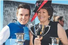  ?? Picture: GRANT PETERS, TRACKSIDE PHOTOGRAPH­Y ?? Jockey Tim Clark and trainer Helen Page after Rudy's Tattersall’s Cup win.