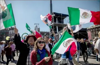  ?? Alejandro Cegarra/Bloomberg ?? Supporters wave Mexican flags Saturday during the presidenti­al inaugurati­on of Andres Manuel Lopez Obrador in Mexico City.