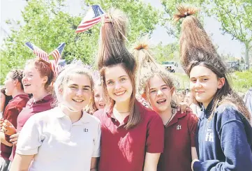  ??  ?? Students wear their hair up like hats at Meghan Markle’s former Los Angeles high school as they stage a ‘Here’s to Meghan!’ celebratio­n ahead of her marriage to Prince Harry, as they celebrate at Immaculate Heart High School in Los Angeles, California...