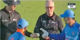  ??  ?? A screengrab shows M.S. Dhoni asking umpires for the match ball after the third ODI against England.