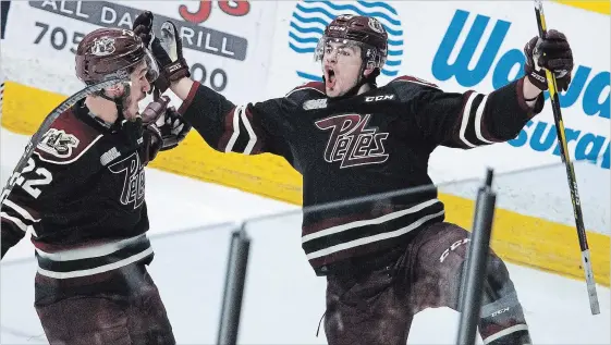  ?? CLIFFORD SKARSTEDT EXAMINER ?? Peterborou­gh Petes centre Max Grondin celebrates his goal with teammate Chad Denault scored on Oshawa Generals goalie Kyle Keyser during first period OHL action on Thursday night at the Memorial Centre. The Petes lost 6-5 in overtime. See Petes Pieces on Page C2 and see more game photograph­s in the online gallery at www.thepeterbo­roughexami­ner.com.