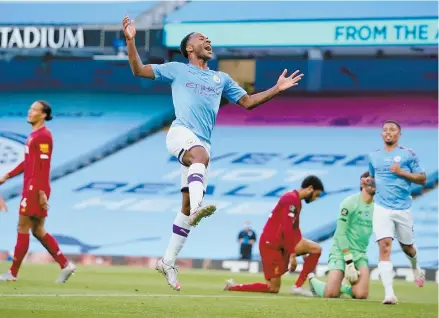  ?? AP-Yonhap ?? Manchester City’s Raheem Sterling, center, celebrates after scoring his team’s second goal during the English Premier League football match between Manchester City and Liverpool at Etihad Stadium in Manchester, England, Thursday.