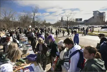  ?? Matthew Dae Smith/Lansing State Journal via AP ?? People gather on the campus of Michigan State University in East Lansing, Mich., for Spartan Sunday. Volunteers are unifying to clean up campus and give to the Spartan community in the wake of the shooting rampage last week.