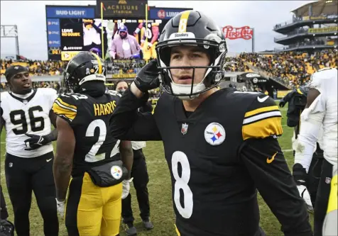  ?? Don Wright/Associated Press ?? Kenny Pickett walks off the Acrisure Stadium field with his first win Sunday.