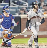  ?? Kathy Willens / Associated Press ?? Mets catcher Wilson Ramos watches Steven Duggar’s RBI single in the Giants’ fourth inning. Duggar also had an RBI double in the 10th.