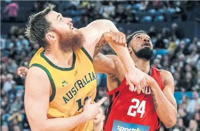  ?? TONY ASHBY AFP/GETTY IMAGES ?? Australia’s Aron Baynes and Khem Birch, who led Canada with 18 points, jostle for position in Perth, Australia on Saturday.