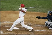  ?? MATT SLOCUM — THE ASSOCIATED PRESS FILE ?? Philadelph­ia Phillies’ J.T. Realmuto follows through after hitting a tworun home run off Atlanta Braves pitcher Robbie Erlin during the fourth inning of a baseball game in Philadelph­ia, in this Monday, Aug. 10, 2020, file photo. Realmuto is a free agent.