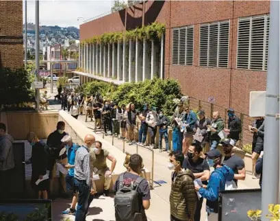  ?? JESSICA CHRISTIAN/AP ?? People stand in long lines to receive the monkeypox vaccine at San Francisco General Hospital in San Francisco on July 12.