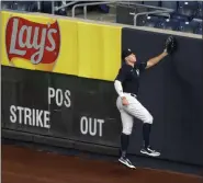  ?? KATHY WILLENS — THE ASSOCIATED PRESS ?? New York Yankees right fielder Aaron Judge practices climbing the outfield wall in front of empty stands during an intrasquad game Monday, July 6, 2020.