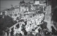  ?? The New York Times/DMITRY KOSTYUKOV ?? The battenti, penitents who flagellate themselves with nails, walk in procession during a week of atonement and parades that re-enact biblical parables in the town of Guardia Sanframond­i, Italy.