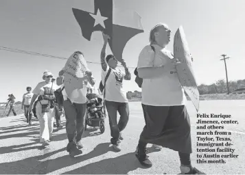  ?? MARK GREENBERG FOR USA TODAY ?? Felix Enrique Jimenez, center, and others march from a Taylor, Texas, immigrant detention facility to Austin earlier this month.