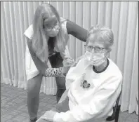 ??  ?? Theresa Will (left), RN, CCHD, administer­s a COVID vaccine to Edith “Karen” Magnuson of Valley City.