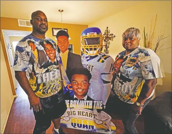  ?? (AP/Gerald Herbert) ?? Kevin and Rontunda Moran, who lost their 17-year-old son Jaquan Anderson to the coronaviru­s, pose with cardboard cutouts of him in their home in New Orleans. Kevin Moran recalls a day when he was getting ready to go vote. Jaquan was 16 and wanted to come along. Moran showed him the voting booth, talked with him about who he was voting for and let him wear the “I Voted” sticker when they were done. “He was really looking forward to being able to vote,” Moran said.