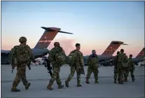  ?? ALLISON JOYCE — VIA TRIBUNE NEWS SERVICE ?? Soldiers of the 82nd Airborne Division walk to board a plane in Fort Bragg, N.C., on Feb. 14, as they are deployed to Europe. A mysterious video by its 4th Psychologi­cal Operations Group-Airborne has raised debate over its intent.