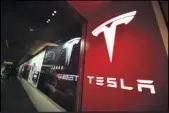  ?? AP PHOTO/DAVID ZALUBOWSKI ?? A sign bearing the company logo outside a Tesla store in Cherry Creek Mall in Denver is seen here on Feb. 9, 2019.
