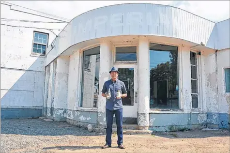  ?? COLIN CHISHOLM ?? Michael Oxner stands in front of the former Stephens and Yeaton garage on Water Street in Windsor. The old business will soon be retrofitte­d into the James Roué Beverage Company, featuring a tasting bar, retail location and small restaurant.