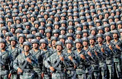  ?? Reuters ?? Soldiers of China’s People’s Liberation Army get ready for the military parade to commemorat­e the 90th anniversar­y of the foundation of the army at Zhurihe military training base in Inner Mongolia Autonomous Region, China, on Sunday. —