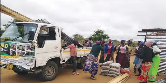  ??  ?? Two storm victims from Matsholomo­tshe and Shortline villages receive building materials sourced through the Rebuild Gwanda Ward One Campaign