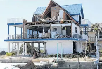  ?? TAIMY ALVAREZ/STAFF PHOTOGRAPH­ER ?? Hurricane Irma's powerful winds sheared off the side of this Cudjoe Key home.