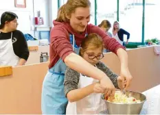  ?? Foto: Wolfgang Werz ?? Gemeinsam geht es besser: Eine Zehntkläss­lerin hilft einem Mädchen aus Ursberg beim Kochen.