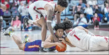  ?? Vasha Hunt The Associated Press ?? Florida guard Zyon Pullin vies for the ball with Alabama guards Aaron Estrada and Mark Sears in overtime of the Crimson Tide’s 98-93 victory at Coleman Coliseum.