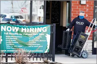  ?? ?? A hiring sign is displayed outside of a Starbucks in Schaumburg, Ill., Friday, April 1, 2022. The number of Americans applying for jobless aid ticked up slightly last week but the total number of Americans collecting benefits remained at its lowest level in more than five decades. Applicatio­ns for unemployme­nt benefits rose by 1,000 to 203,000 for the week ending May 7, the Labor Department reported Thursday, May 12. (AP )