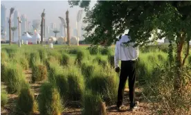  ?? ?? A member of security staff near the Al Bidda Park, Doha. Guards say they know they are being underpaid but feel powerless to act. Photograph: Pete Pattisson