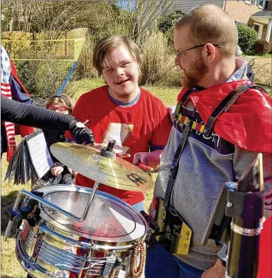  ??  ?? Myles Howard of Woodstock celebrates turning 20 on Feb. 29 with the help of The Feed & Seed Marching Abominable. The allvolunte­er band often donates its time to play for worthy causes, and members were touched by a request from Myles’ dad.