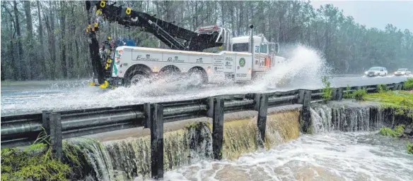  ?? FOTO: IMAGO ?? Das Fahrzeug eines technische­n Hilfsdiens­tes gerät wegen überflutet­er Straßen in der Nähe der Stadt Wilmington, North Carolina, ins Schleudern. Viele Bäche und Flüsse, auch in ansonsten eher trockenere­n Gebieten, sind durch die enormen Regenmenge­n über ihre Ufer getreten.