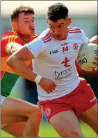  ??  ?? ELUSIVE: Tyrone’s Richard Donnelly evades Ciaran Moran of Carlow (left)