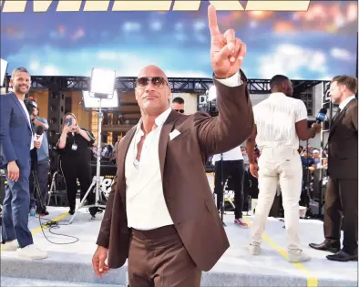  ?? Emma McIntyre / Getty Images ?? Dwayne Johnson arrives at the premiere of Universal Pictures' "Fast & Furious Presents: Hobbs & Shaw" at Dolby Theatre on July 13. Johnson, a co-owner of the XFL, announced the league’s 2022 return in a Thursday statement.