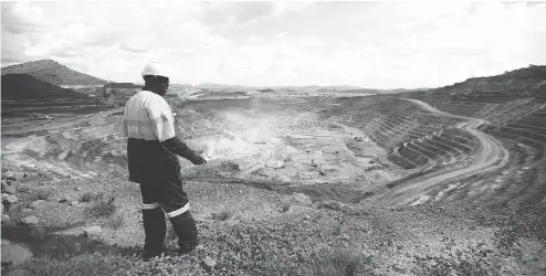  ?? SIMON DAWSON / BLOOMBERG ?? A worker watches from the rim of the Congo’s Kibali gold mine, one of the assets operated by Randgold Resources which is merging with Barrick Gold.