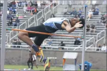  ?? STAFF PHOTOS BY MICHAEL REID ?? La Plata’s Alex Strong soars over the bar on his way to a second-place finish in the Class 2A high jump with a height of 6 feet 4 inches on Saturday at Morgan State University in Baltimore.