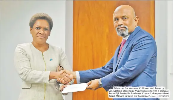  ?? Picture: LUKE NACEI ?? Minister for Women, Children and Poverty Alleviatio­n Mereseini Vuniwaqa receives a cheque from Fiji Australia Business Council vice-president Saud Minam in Suva on Tuesday.