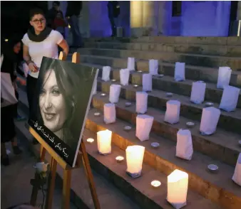  ?? (Reuters) ?? A PHOTO of murdered British Embassy worker Rebecca Dykes is displayed during a candlelit sit-in organized by activists in Beirut on Saturday night.