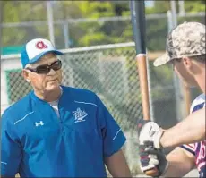  ?? Loren Holmes ?? STU PEDERSON, currently a coach at a college summer league club in Anchorage, gives advice to infielder Kevin Viers before a game.