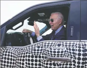  ?? (File Photo/AP/Evan Vucci) ?? President Joe Biden stops to talk to the media Tuesday as he drives a Ford F-150 Lightning pickup at Ford Dearborn Developmen­t Center in Dearborn, Mich. On Friday, The Associated Press reported on stories circulatin­g online incorrectl­y claiming Biden was caught fake driving a Ford F-150 Lightning during a visit to a Ford safety testing center Tuesday.