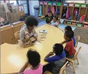 ?? JEREMY P. KELLEY / STAFF ?? Students at a Miami Valley Child Developmen­t Centers preschool work on a craft activity with their teacher.