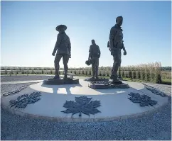  ?? ANDREW VAUGHAN / THE CANADIAN PRESS ?? A memorial to RCMP Constables Fabrice Gevaudan, Dave Ross and Doug Larche, who were gunned down in 2014.