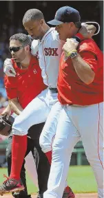  ?? STAFF PHOTO BY CHRISTOPHE­R EVANS ?? HURTING: Chris Young is carried off the field by head trainer Brad Pearson and manager John Farrell after pulling his hamstring in the second inning.