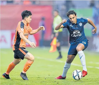  ??  ?? Buriram forward Diogo Luis Santo, right, in action during a match this season.