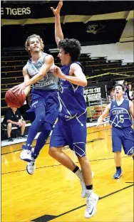  ?? Photo by Mike Eckels ?? Decatur’s Taylor Haisman goes airborne for a layup as a Cedarville player tries to block his shot during the Bulldogs-Pirates game on July 14.